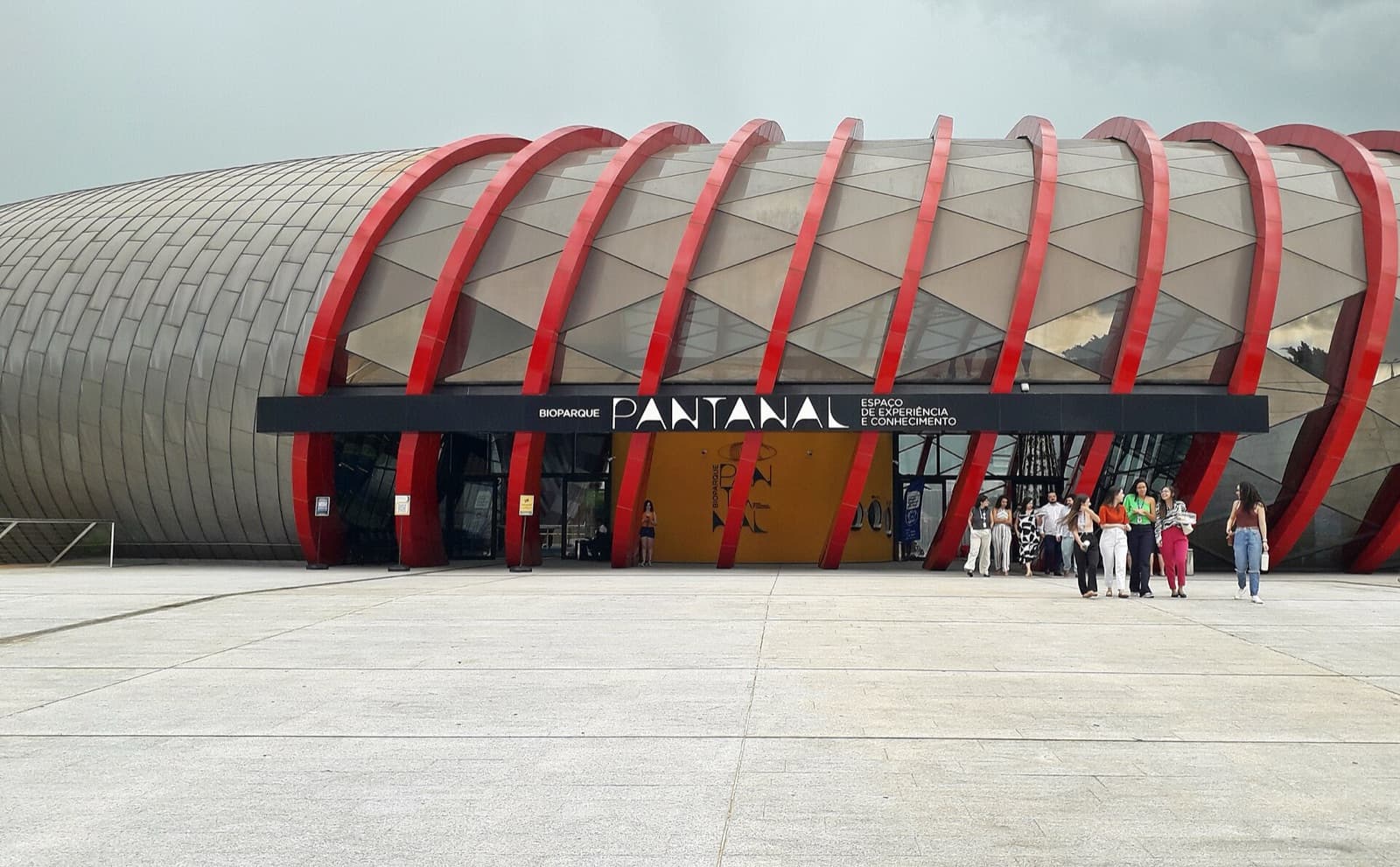 Curved metal facade with red arches at the entrance to Bioparque Pantanal, the freshwater aquarium in Campo Grande, Mato Grosso do Sul