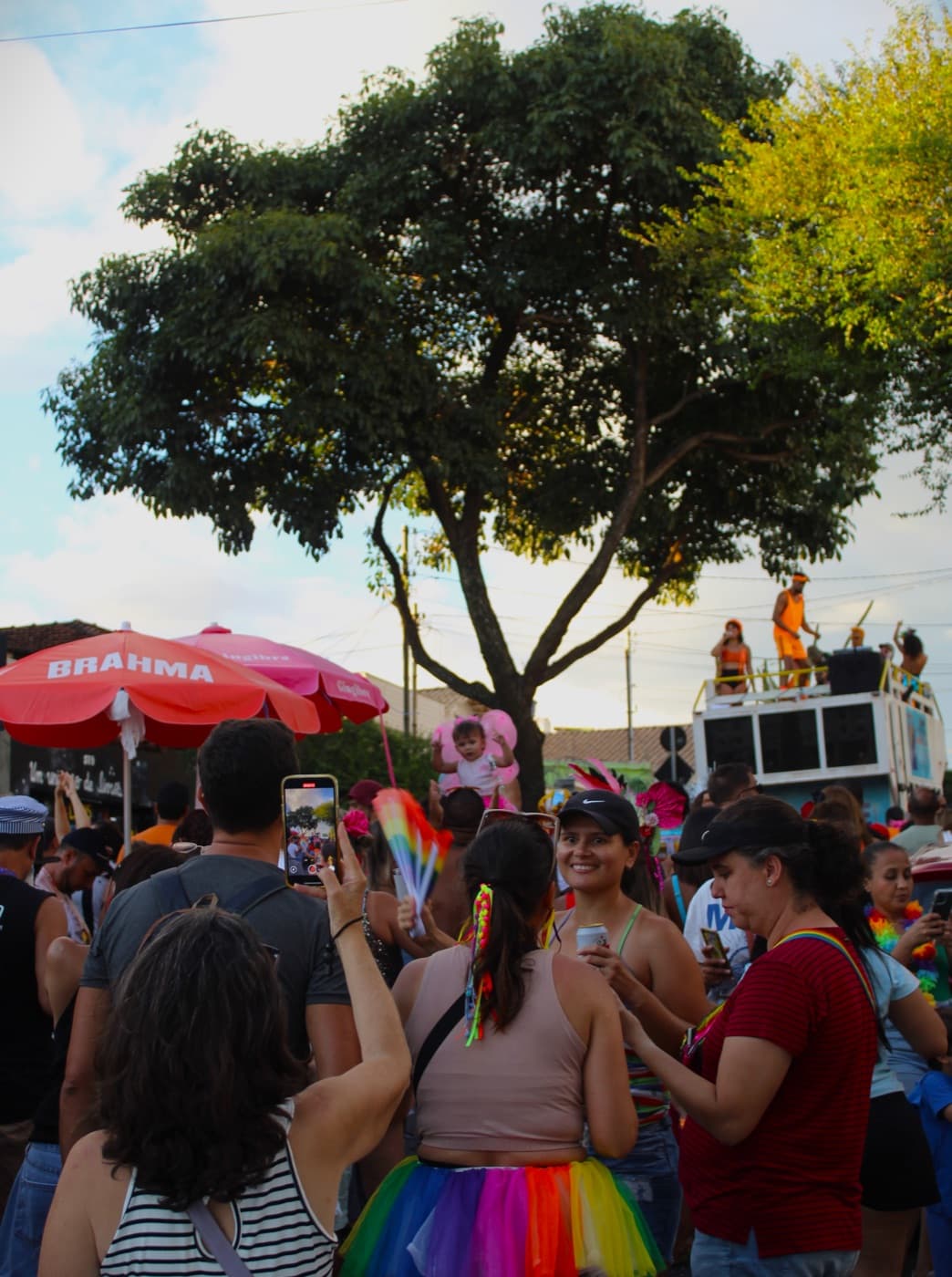 Revelers in colorful costumes and glitter celebrating with a neighborhood bloco on the last day of Carnival in Belo Horizonte.