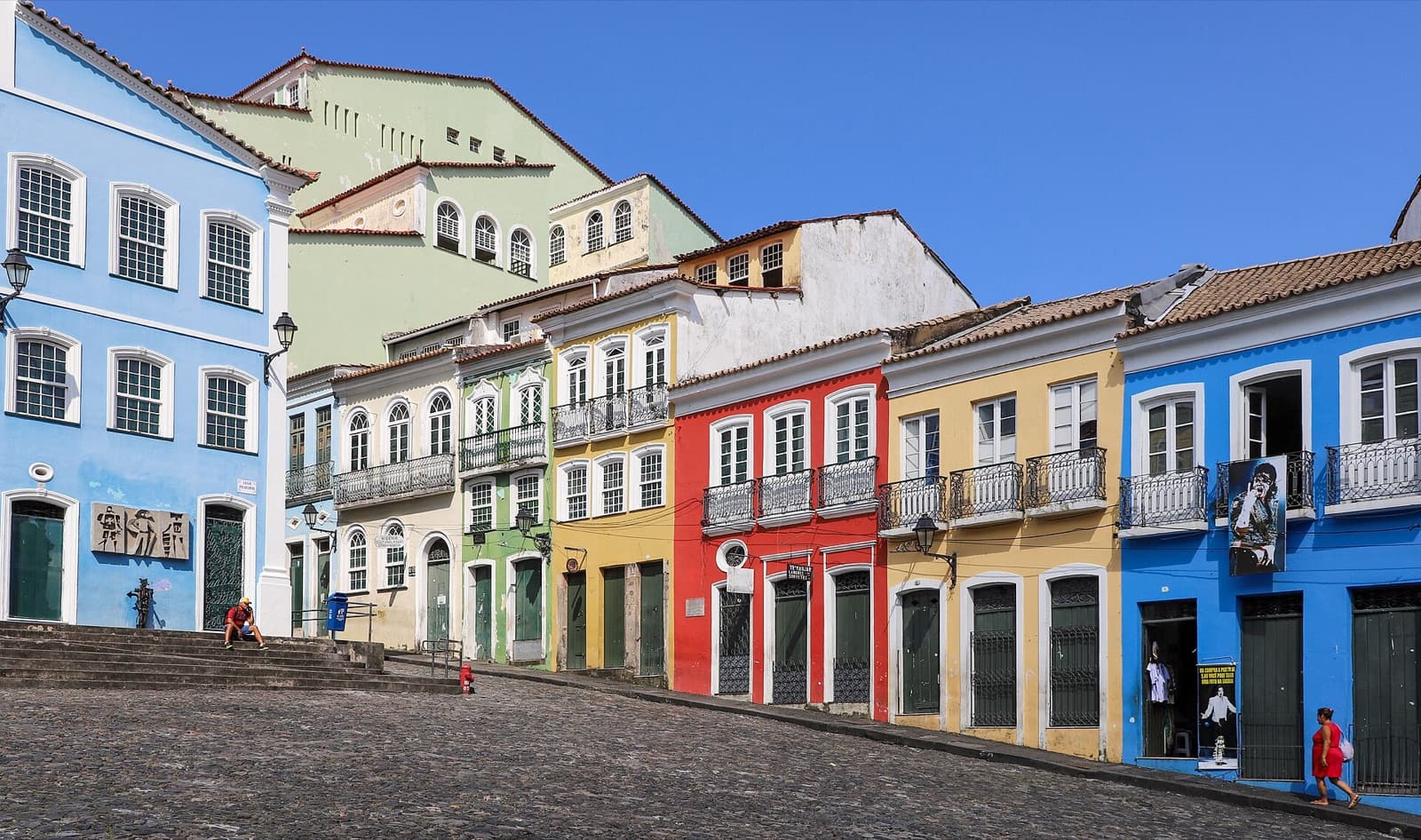 Colorful colonial houses along the cobbled slope of the Largo do Pelourinho in Salvador's historic center on a sunny day