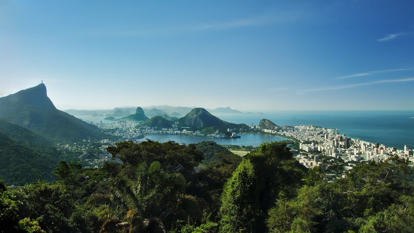 View from the Vista Chinesa viewpoint in Tijuca National Park, with forest in the foreground and Corcovado, the Lagoa Rodrigo de Freitas, Ipanema, and the sea beyond