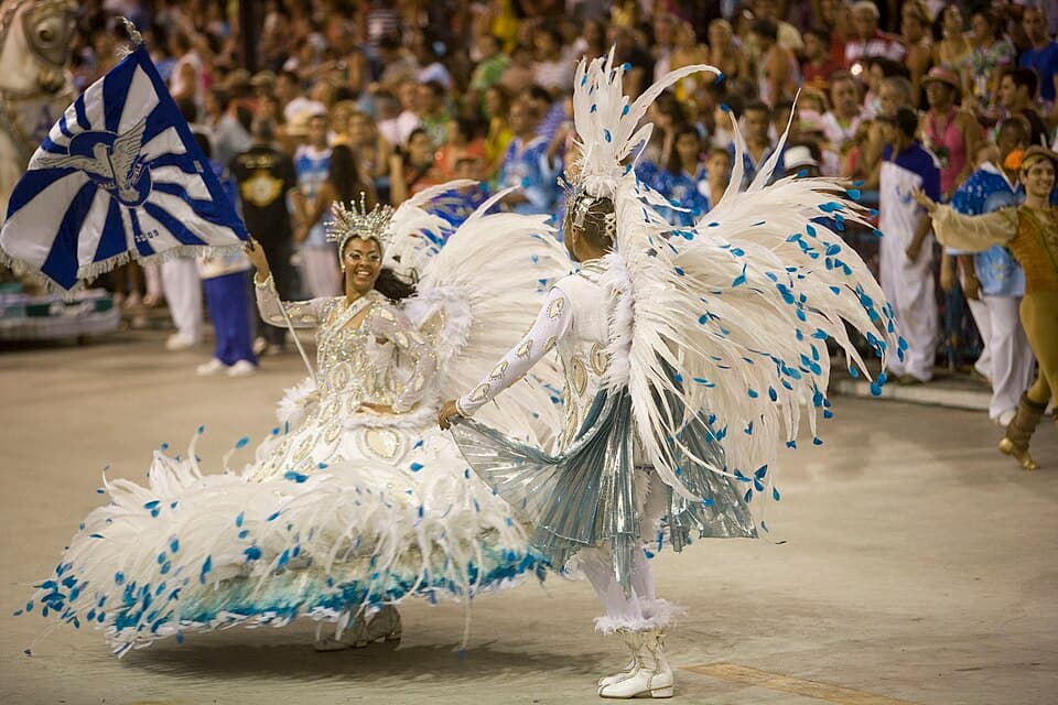 Flag bearer and escort performing at the Sambadrome during a samba parade in Rio de Janeiro.